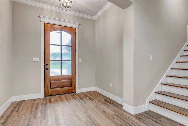 entrance foyer featuring light wood-type flooring and crown molding