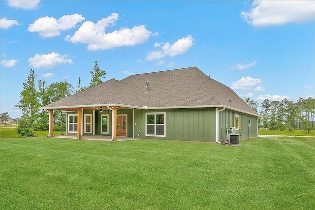 rear view of house featuring a lawn, central AC unit, and a patio