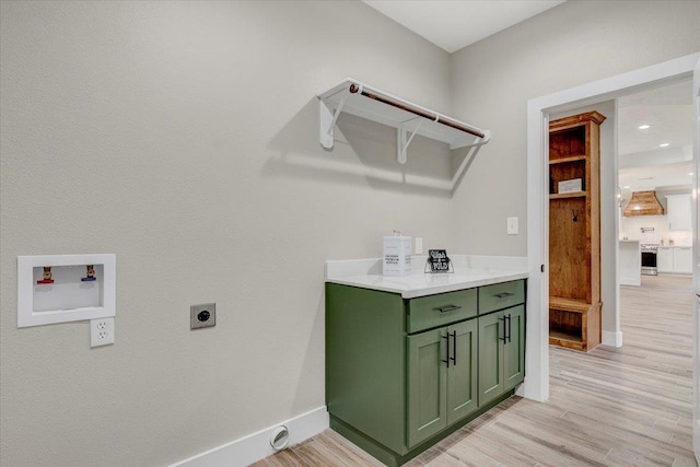 laundry area featuring hookup for a washing machine, light wood-type flooring, and hookup for an electric dryer