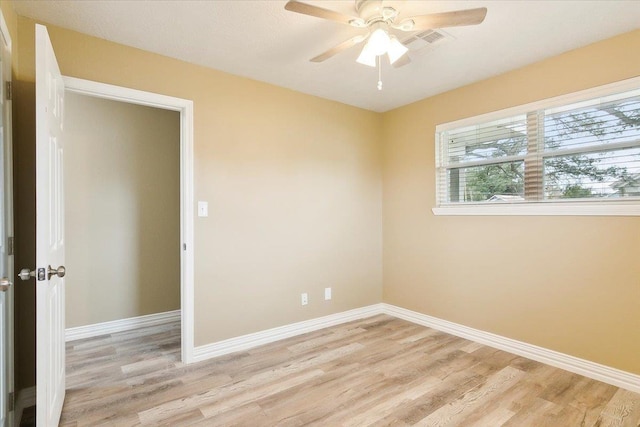 empty room featuring ceiling fan and light hardwood / wood-style flooring