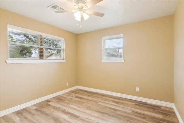 spare room featuring light hardwood / wood-style floors and ceiling fan