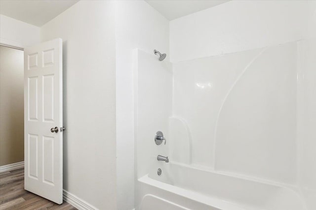 bathroom with shower / bath combination and wood-type flooring