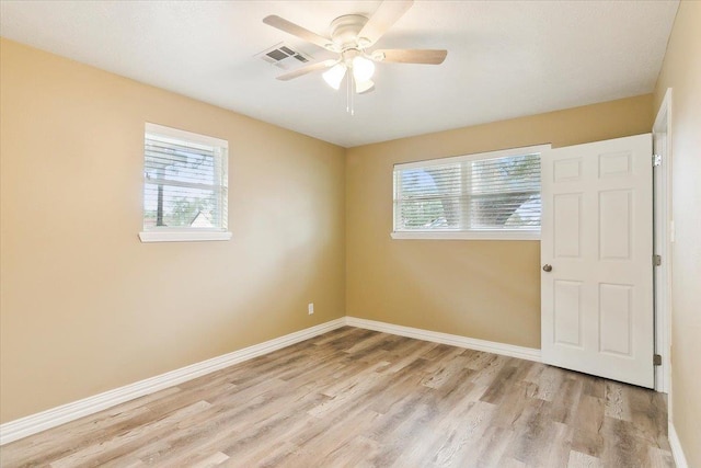 spare room featuring light hardwood / wood-style floors and ceiling fan