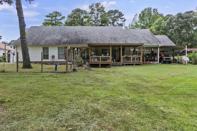 rear view of property with a yard and a carport