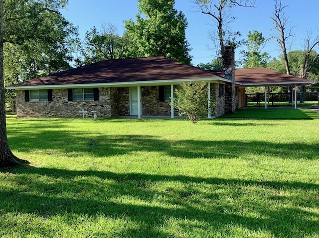 exterior space featuring a carport, a chimney, a front lawn, and brick siding