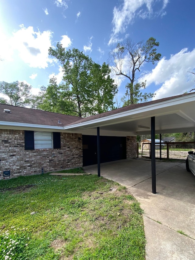 exterior space featuring an attached carport and driveway