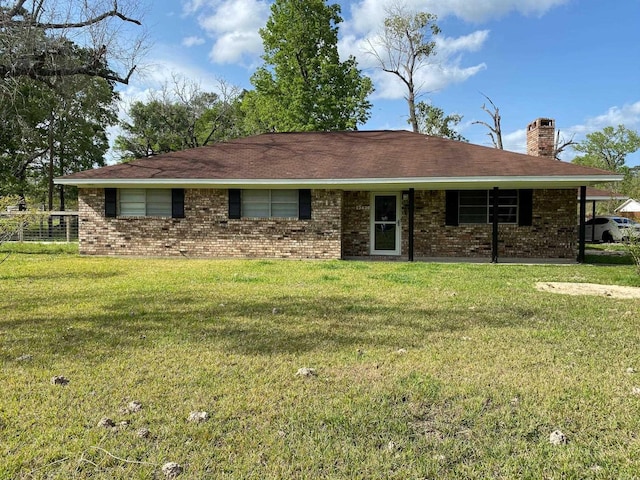 ranch-style house featuring brick siding, a chimney, and a front lawn