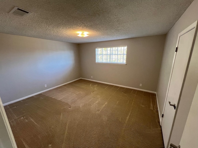 unfurnished bedroom with dark colored carpet and a textured ceiling