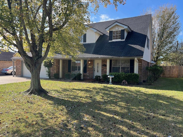 view of front of property with a front yard and a garage