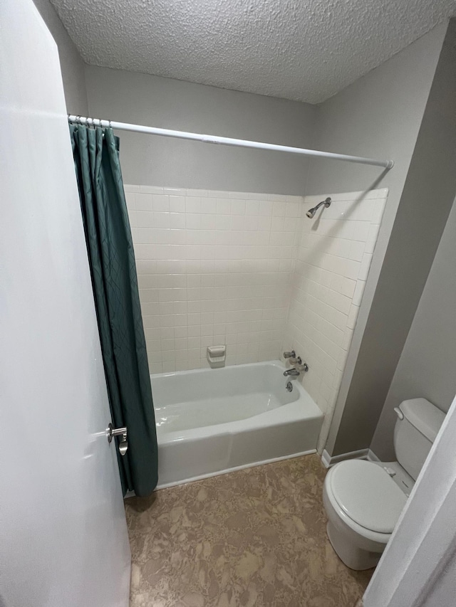 bathroom with shower / bath combo, a textured ceiling, and toilet