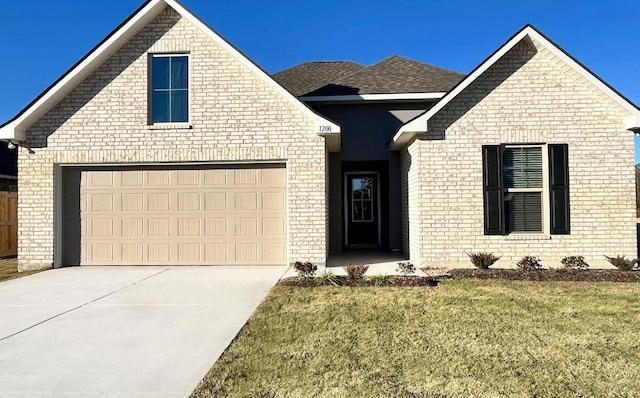 view of front of property featuring a garage and a front yard