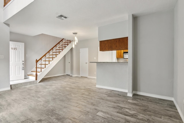 unfurnished living room featuring hardwood / wood-style flooring