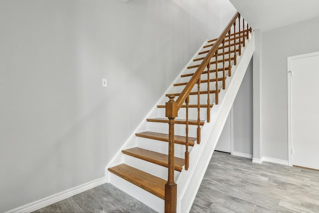 stairs featuring hardwood / wood-style flooring