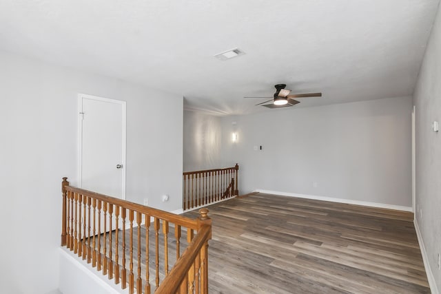 empty room featuring dark hardwood / wood-style flooring and ceiling fan