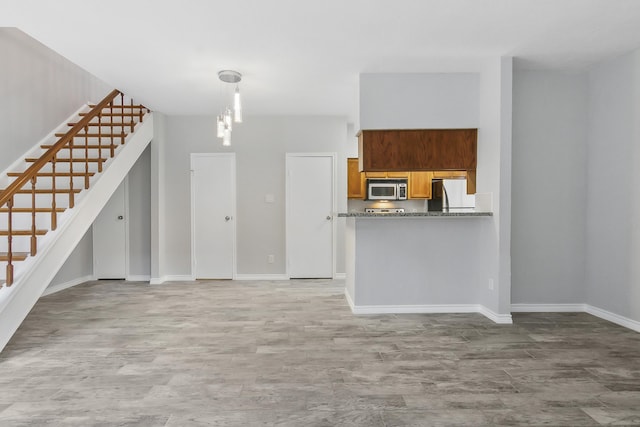 unfurnished living room featuring light wood-type flooring