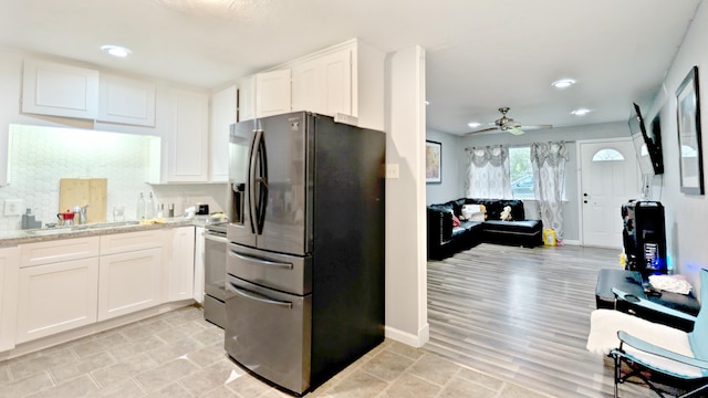 255 Smelker St, Beaumont, TX 77707 - kitchen featuring fridge with ice dispenser, a sink, white cabinetry, stainless steel stove, and a ceiling fan