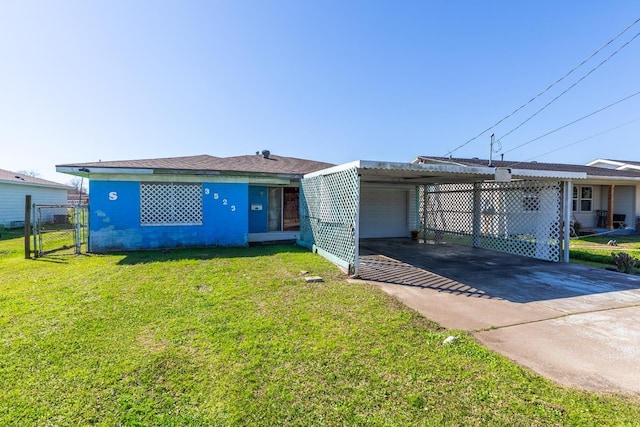 view of front of property featuring driveway, a garage, a gate, fence, and a front yard