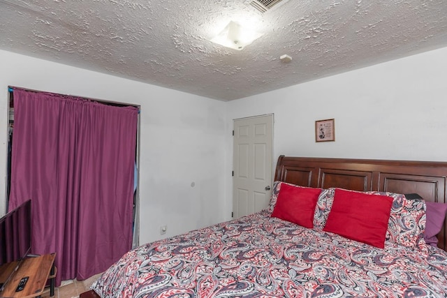 bedroom with visible vents and a textured ceiling