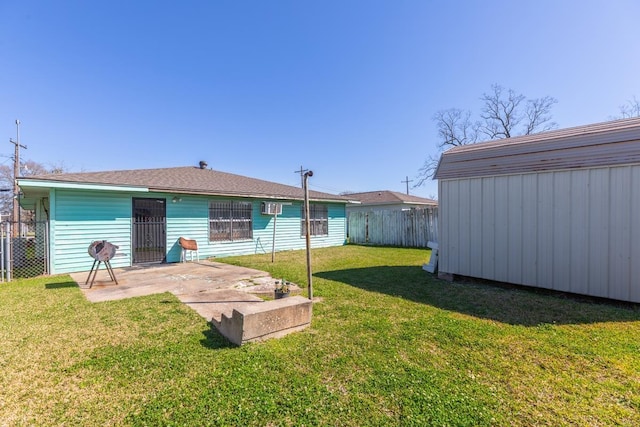 rear view of house featuring a patio, a fenced backyard, a yard, a shed, and an outdoor structure