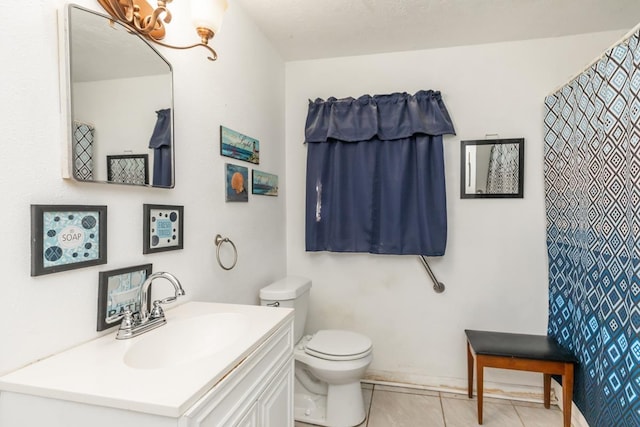 full bathroom with toilet, tile patterned flooring, and vanity