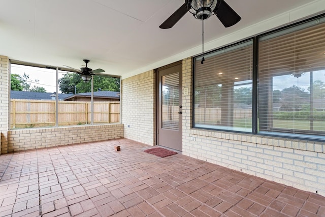 view of patio / terrace with ceiling fan and fence