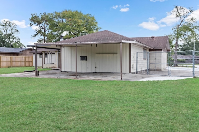 back of house with a shingled roof, a yard, a patio, and fence