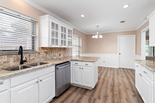 kitchen with crown molding, white cabinetry, dishwasher, and a sink