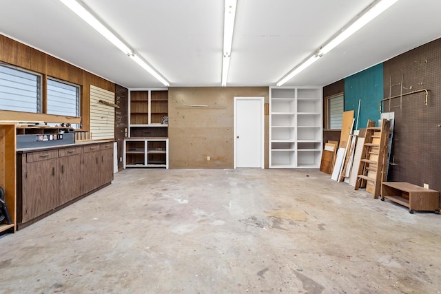 garage featuring wood walls and a workshop area