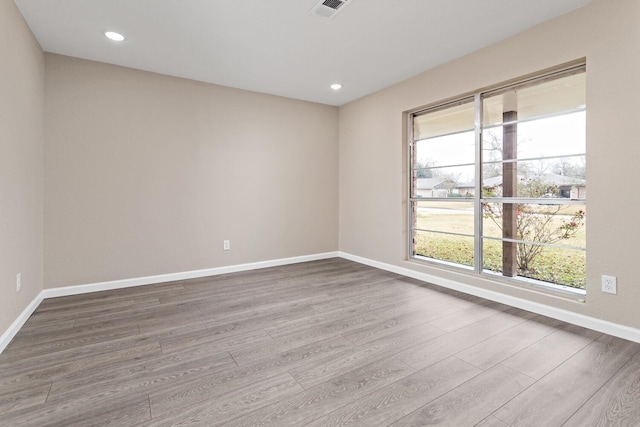 spare room featuring hardwood / wood-style floors