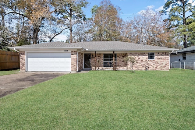 ranch-style home featuring a garage and a front lawn