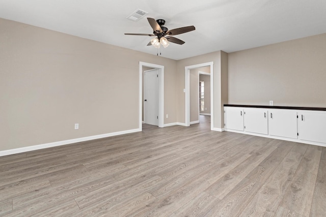 empty room featuring ceiling fan and light wood-type flooring