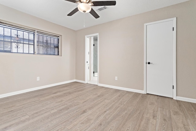 empty room featuring ceiling fan and light wood-type flooring