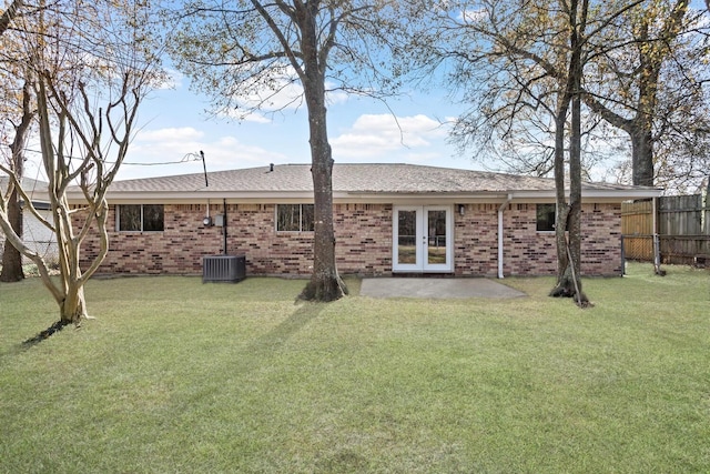 rear view of house featuring french doors, a yard, and a patio area