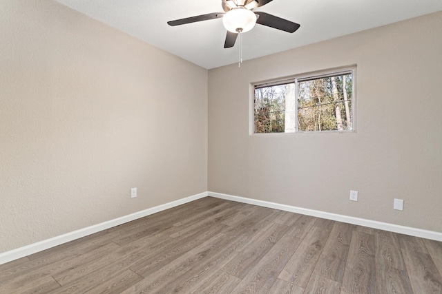 empty room featuring ceiling fan and wood-type flooring