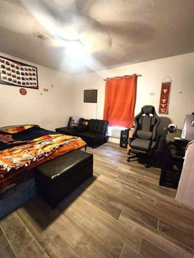 455 Creekwood Dr, Lumberton, TX 77657 - bedroom with a ceiling fan, wood tiled floor, and a textured ceiling