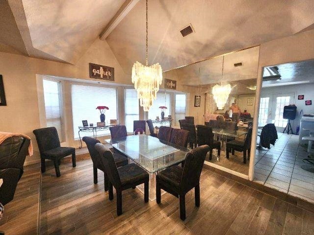 455 Creekwood Dr, Lumberton, TX 77657 - dining room featuring dark wood-style floors, a notable chandelier, visible vents, high vaulted ceiling, and beamed ceiling
