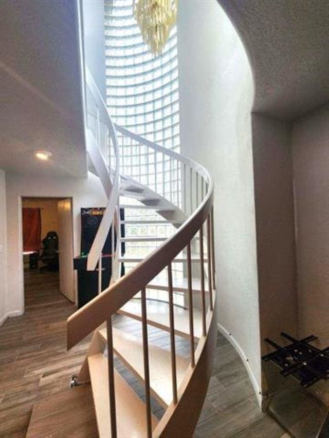 455 Creekwood Dr, Lumberton, TX 77657 - stairway with a chandelier, baseboards, and wood finished floors