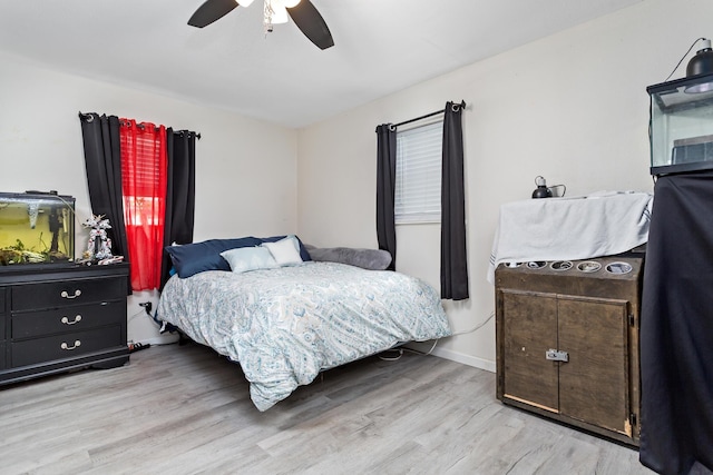 bedroom with baseboards, a ceiling fan, and wood finished floors