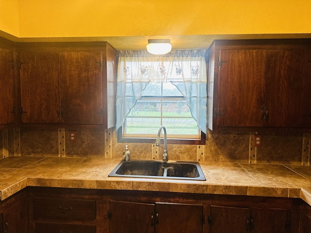 kitchen featuring dark brown cabinetry and sink