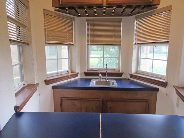620 20th St, Beaumont, TX 77706 - kitchen with track lighting, plenty of natural light, and dark countertops