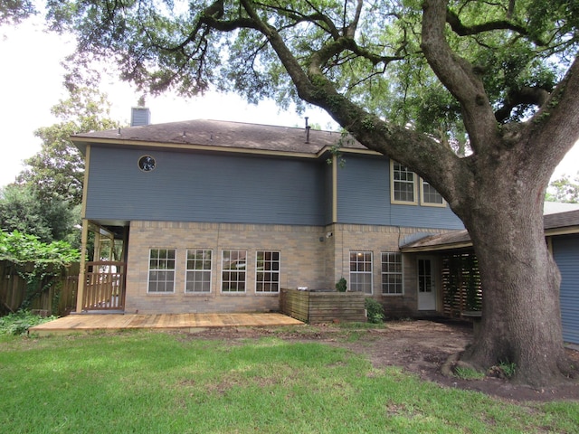 620 20th St, Beaumont, TX 77706 - rear view of property featuring brick siding and a chimney