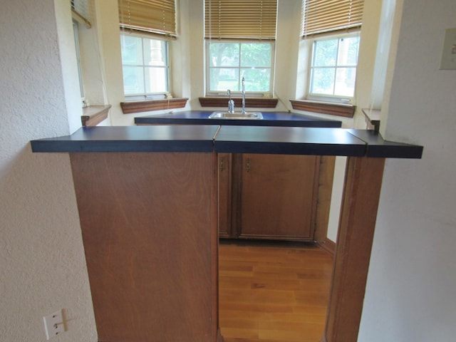 620 20th St, Beaumont, TX 77706 - kitchen with dark countertops, plenty of natural light, wood finished floors, and a textured wall