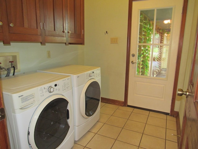 620 20th St, Beaumont, TX 77706 - laundry room featuring washing machine and clothes dryer, cabinet space, and light tile patterned floors