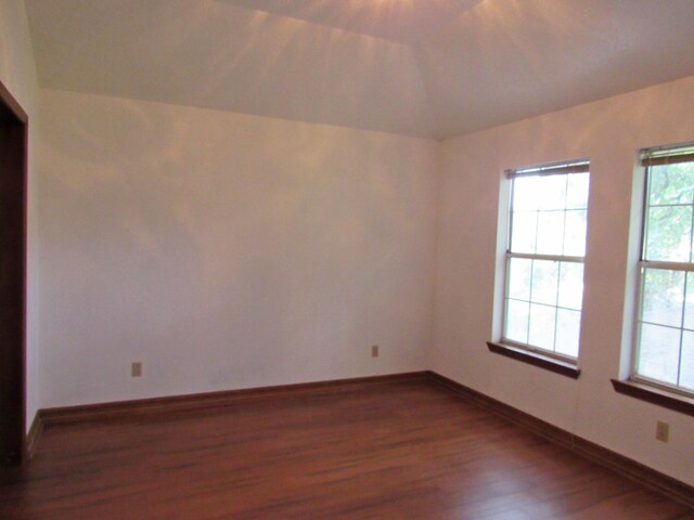 620 20th St, Beaumont, TX 77706 - unfurnished room with dark wood finished floors, plenty of natural light, and lofted ceiling