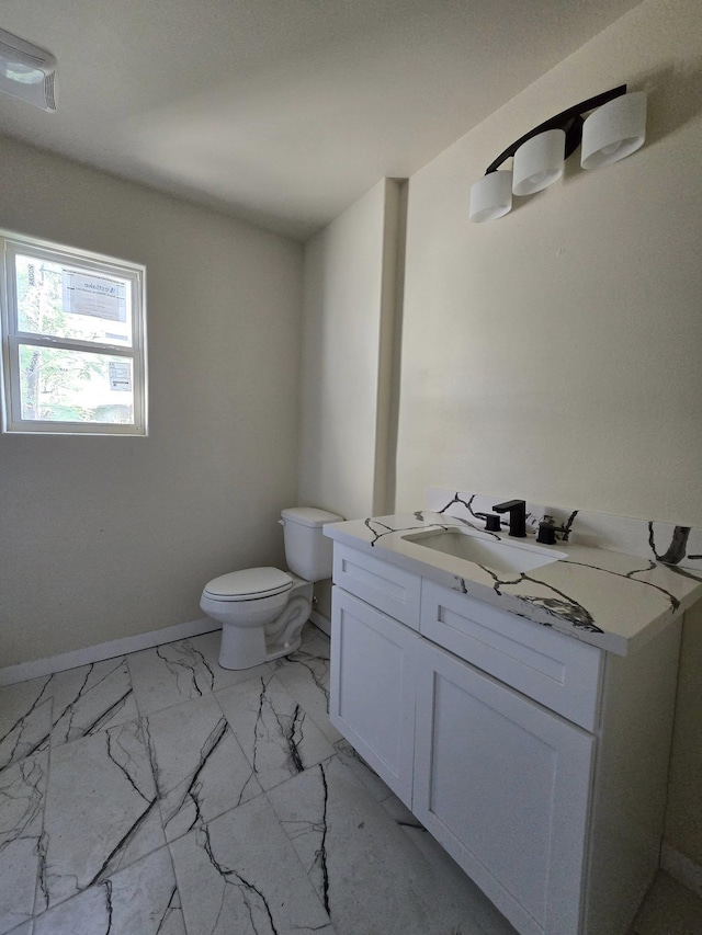 3435 Kenwood Dr, Beaumont, TX 77706 - bathroom featuring marble finish floor, baseboards, toilet, and vanity
