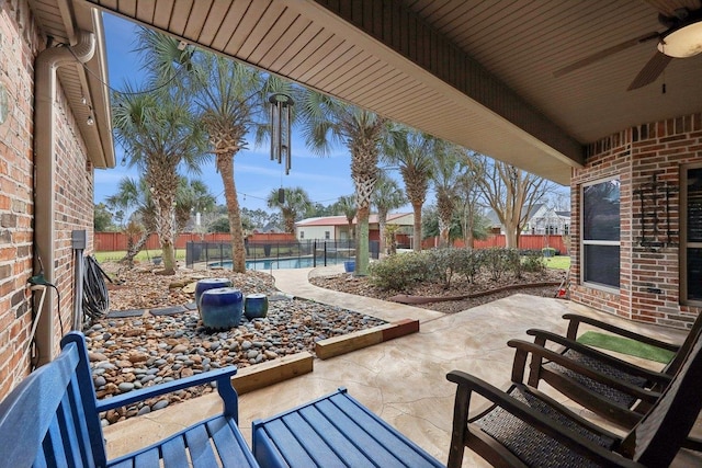 view of patio with a fenced backyard, a fenced in pool, and a ceiling fan