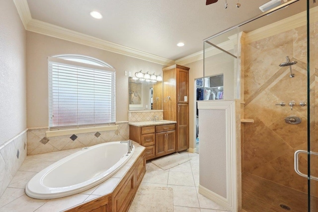 full bath featuring ornamental molding, a stall shower, a garden tub, and vanity