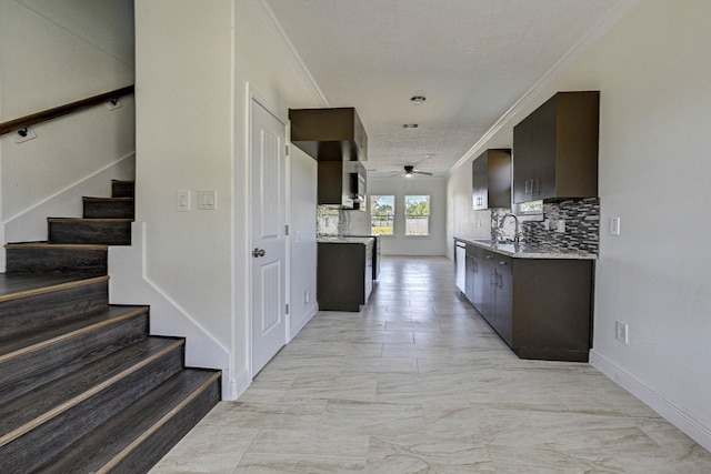 kitchen with decorative backsplash, ceiling fan, dark brown cabinets, and crown molding