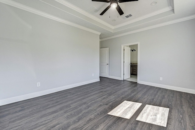 spare room with ceiling fan, a raised ceiling, dark wood-type flooring, and crown molding