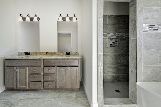 bathroom featuring tiled shower and vanity